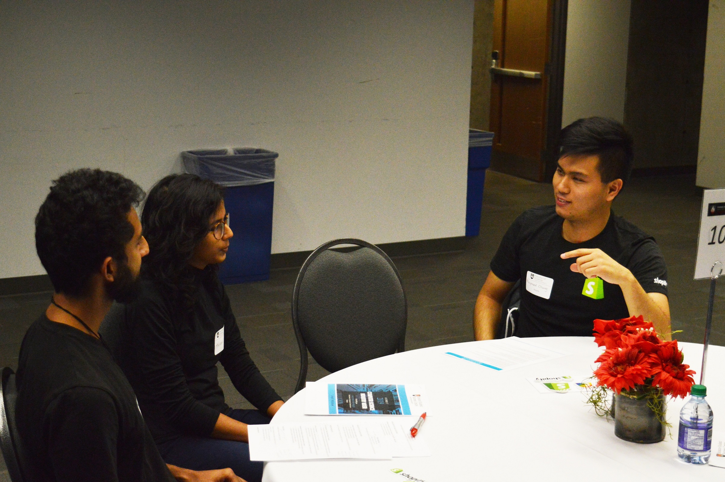 students networking with a professional from Shopify